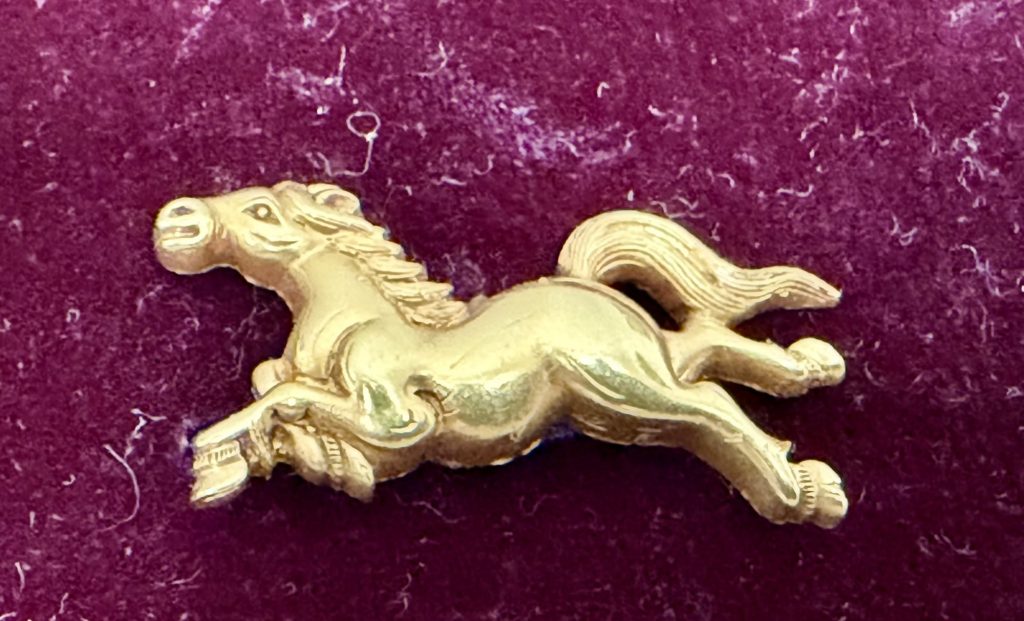 The second horse runs with its head up and forward, mane and tail flying, the hooves finely cut.