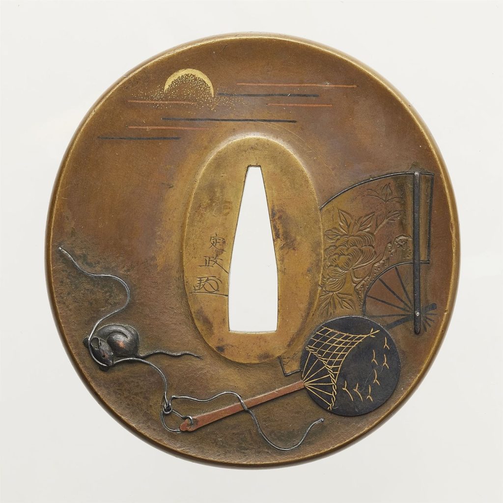 The front of the Okamoto Sadamasa tsuba: a gold moon in bands of mist, a folding fan and a war fan on the right, a silver rat holding the fan cord at the lower left.