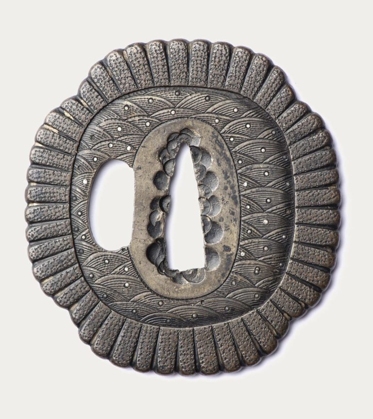 The other face, also covered with seigaiha, the tang opening lined with small plugs.