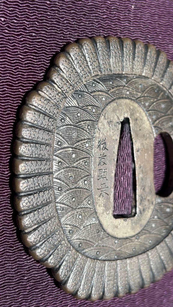 Detail of the rim: each chrysanthemum petal ribbed and punched, the waves inside set with small silver dots.
