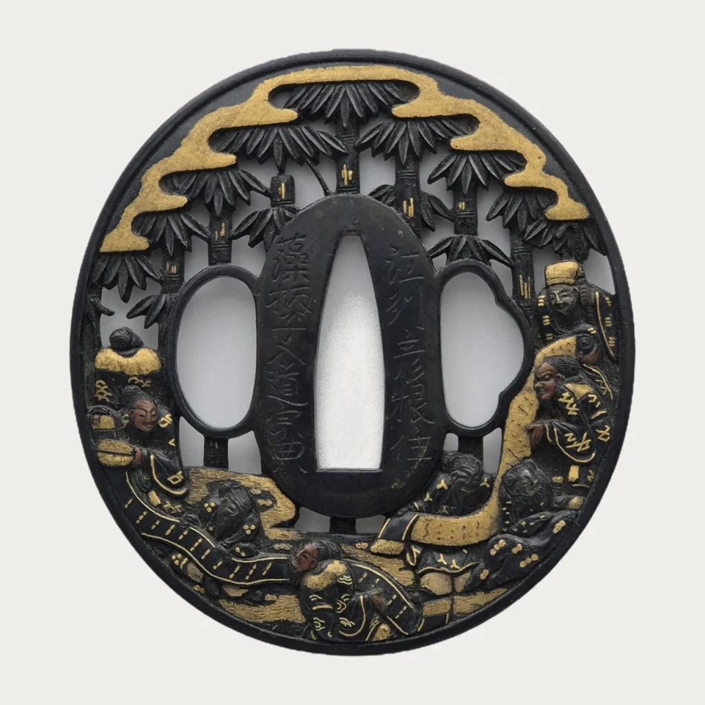 The front of the Soten tsuba: a bamboo grove pierced through the shakudo plate, gold clouds along the top and the sages among the stems below.