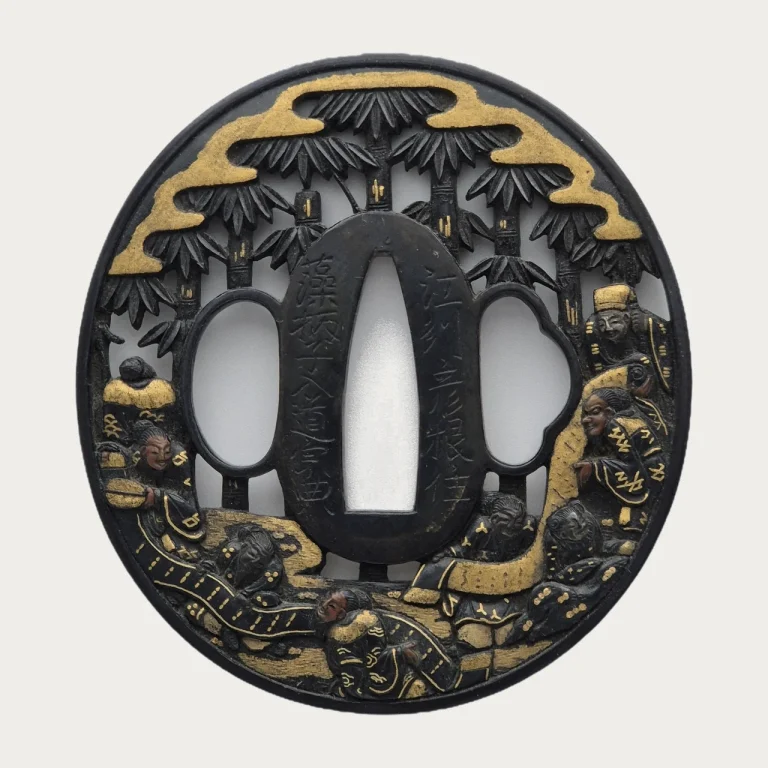 The front of the Soten tsuba: a bamboo grove pierced through the shakudo plate, gold clouds along the top and the sages among the stems below.