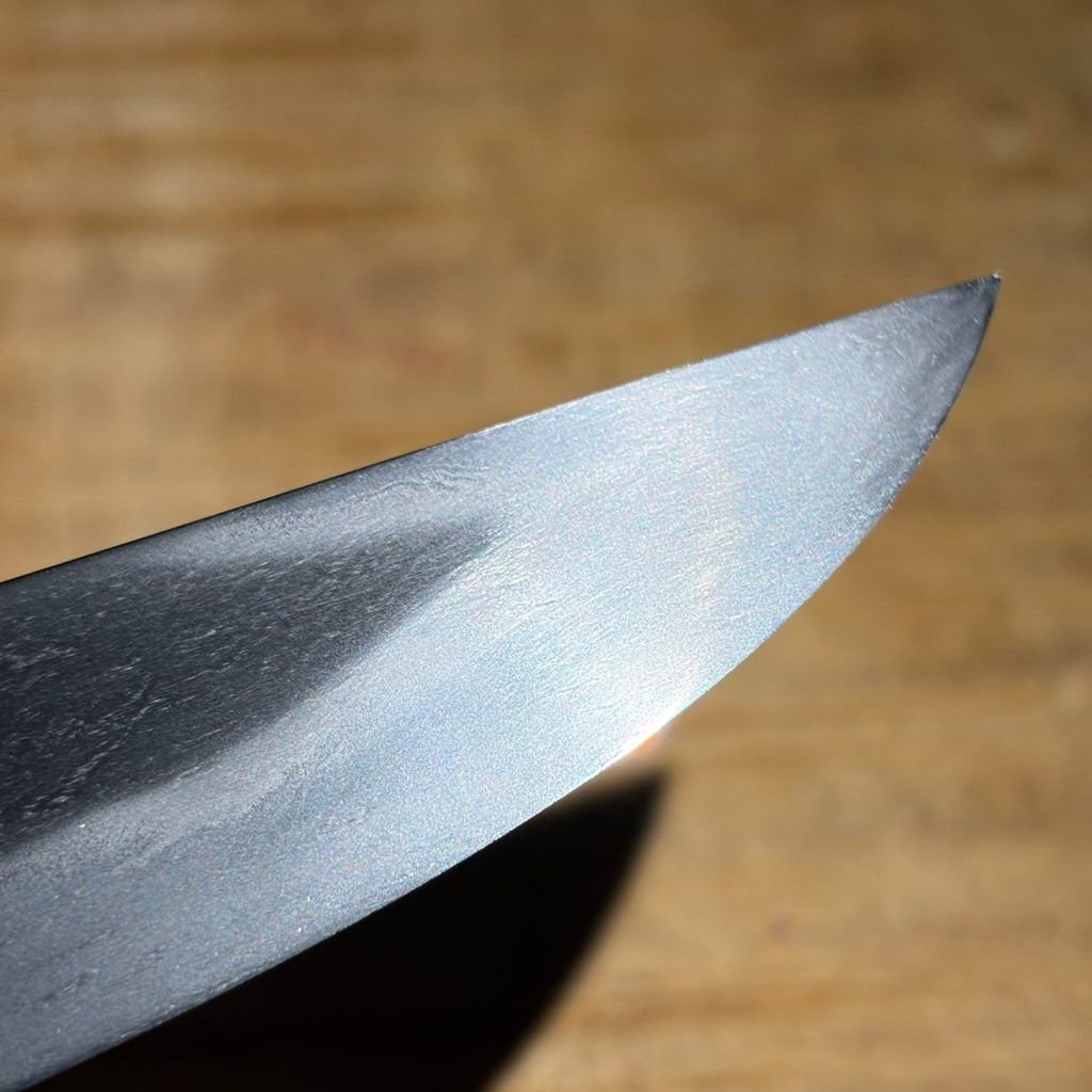 The point of the blade, the hamon following the curve of the fukura.